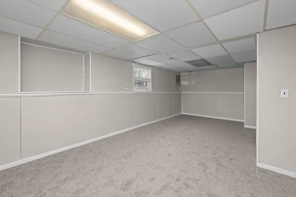 a view of a livingroom with an empty space and a window