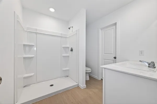 a bathroom with a shower toilet and sink