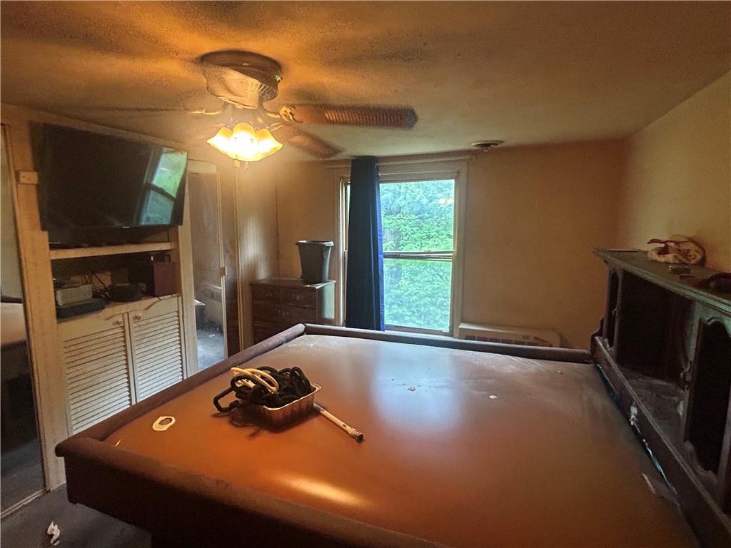 108 Leneake Street Turtle Creek, PA 15145 - Photo 14 of 23 a room with furniture and a flat screen tv