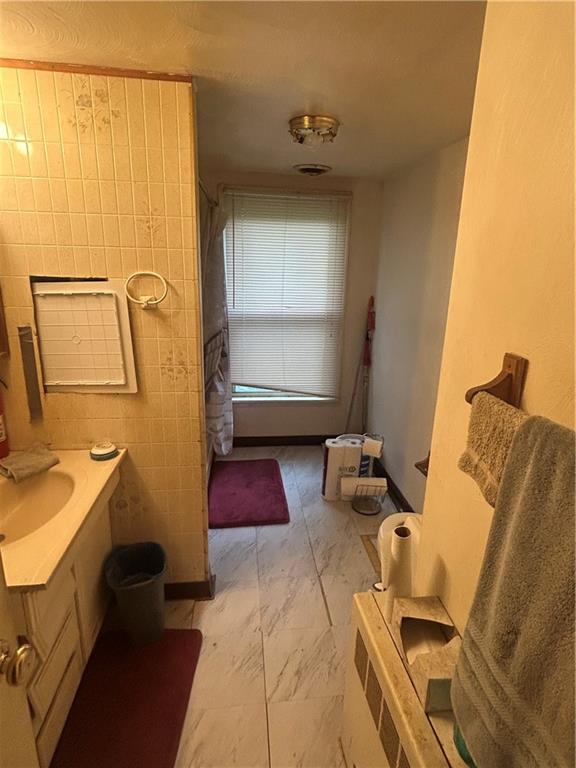 108 Leneake Street Turtle Creek, PA 15145 - Photo 15 of 23 a bathroom with a tub sink and mirror