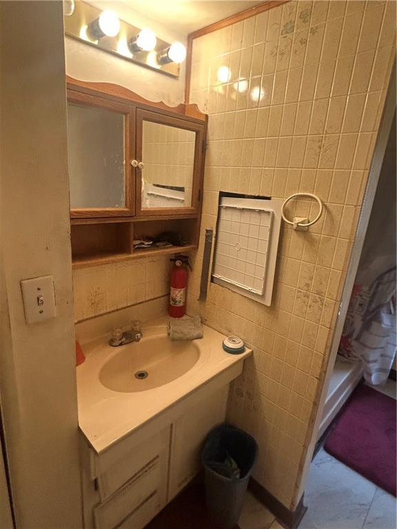 108 Leneake Street Turtle Creek, PA 15145 - Photo 16 of 23 a bathroom with a sink and mirror