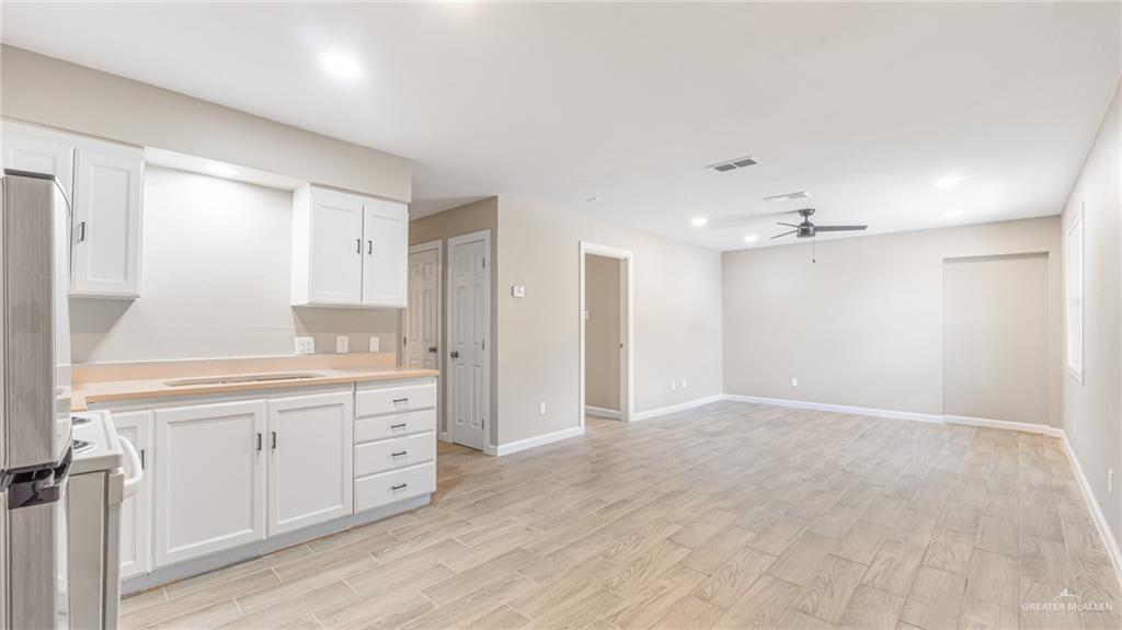 712 Toronto Avenue, Unit 7 McAllen, TX 78503 - Photo 4 of 12 a view of a kitchen with granite countertop cabinets and wooden floor