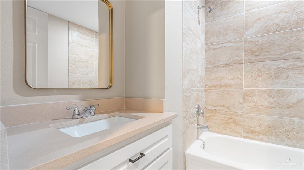 712 Toronto Avenue, Unit 7 McAllen, TX 78503 - Photo 8 of 12 a bathroom with a sink and a bathtub