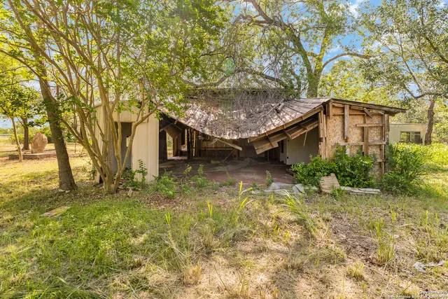 a house is sitting in middle of forest