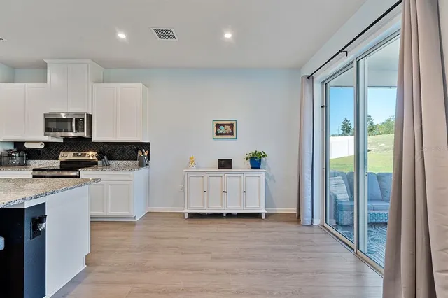 a kitchen with cabinets wooden floor and a sink