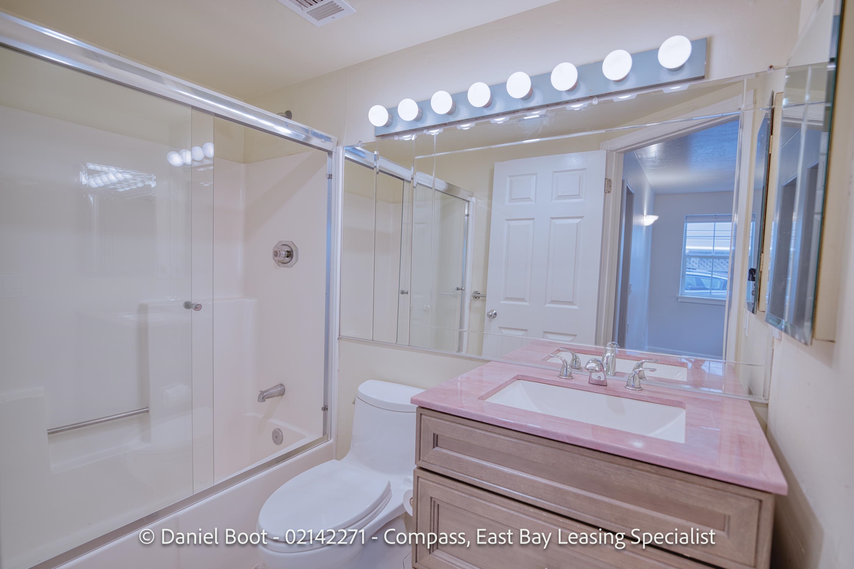 2141 Ward Street Berkeley, CA 94705 - Photo 21 of 41 a bathroom with a sink a toilet a mirror and shower