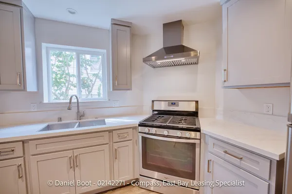a kitchen with cabinets appliances and a sink