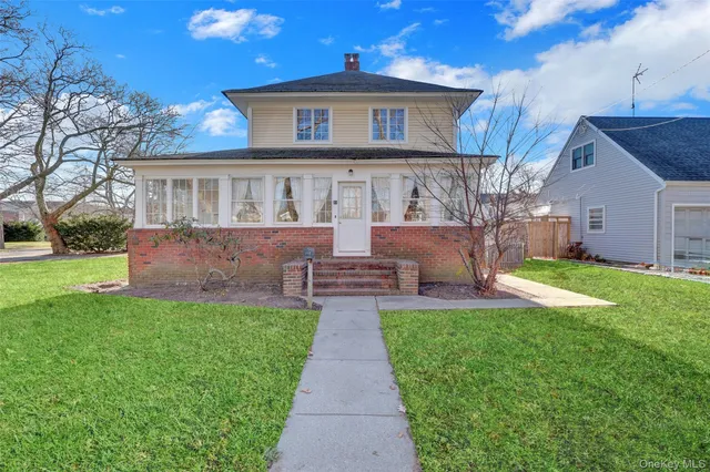 a front view of a house with a garden and yard