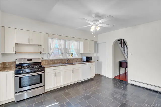 a kitchen with stainless steel appliances a stove a sink and cabinets