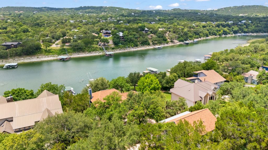 10800 Beach Road Leander, TX 78641 - Photo 35 of 39 Discover waterfront living with private docks, nestled amidst a lush, wooded landscape.