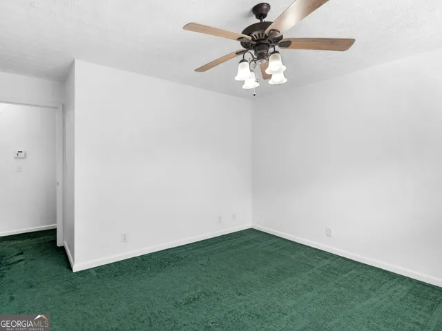 a kitchen with a cabinets a sink a window and stainless steel appliances