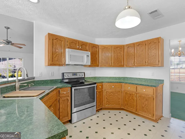 a white refrigerator freezer sitting inside of a kitchen