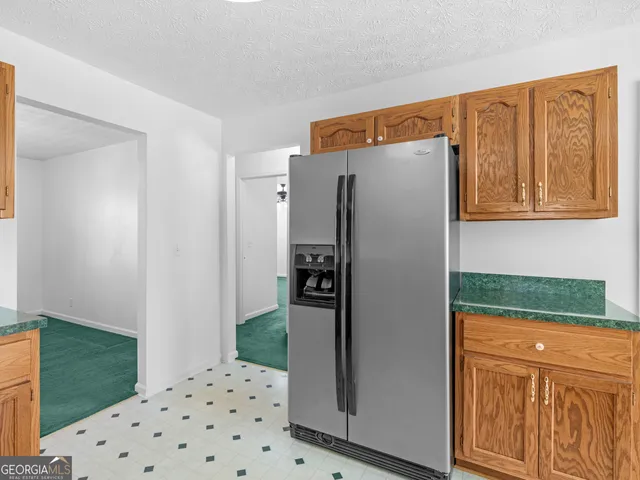 a kitchen with stainless steel appliances granite countertop a sink and a stove