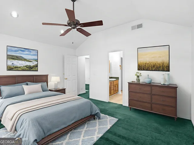 a view of a room with a ceiling fan and windows