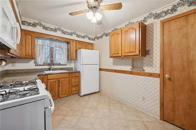 a kitchen with a refrigerator sink stove and cabinets