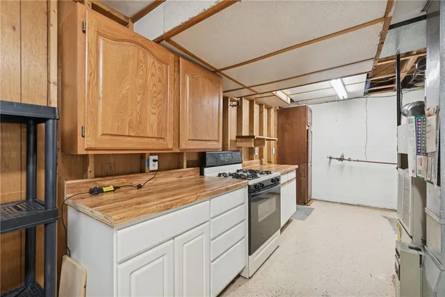 a kitchen with a stove a refrigerator and a sink
