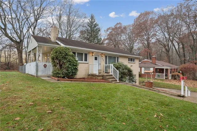 a front view of house with yard and green space