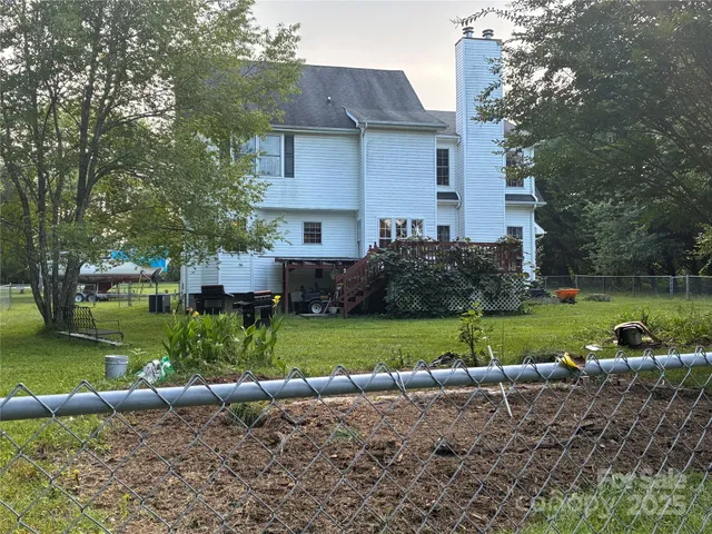 a view of a house with a yard and a garden
