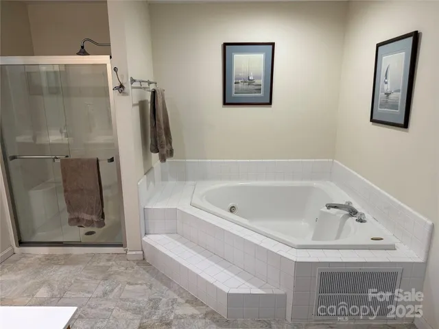a bathroom with a bathtub and a shower