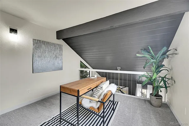 a balcony with furniture and a potted plant