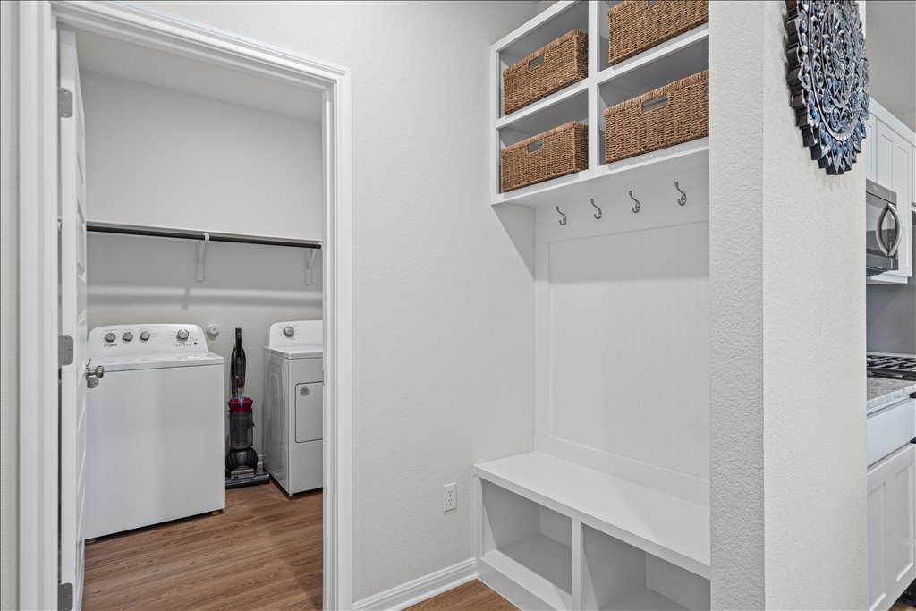158 Gullivers Drive Elgin, TX 78621 - Photo 10 of 36 Right off the main entry area, tucked away perfectly, is this fantastic mudroom setup. You’ve got a custom built-in bench, storage cubbies below and coat hooks to keep everything organized.