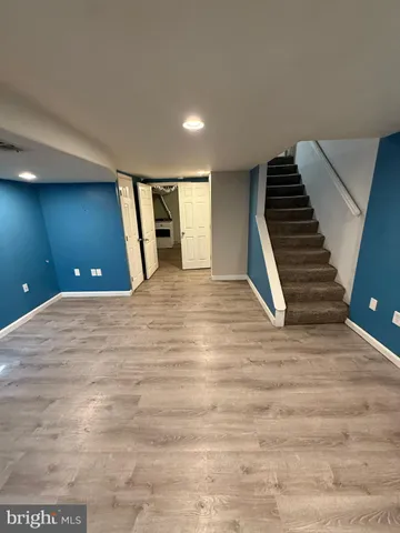 a view of a room with stairs and a hall