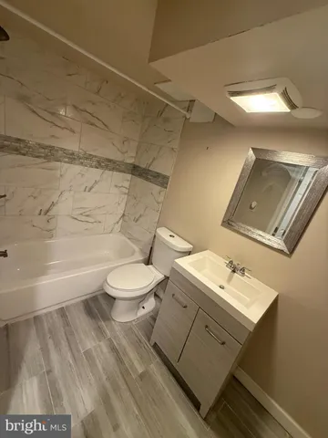 a bathroom with a toilet a sink and bathtub