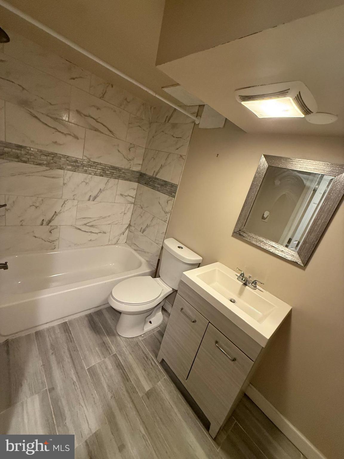 415 Grovethorn Road Baltimore, MD 21220 - Photo 14 of 16 a bathroom with a toilet a sink and bathtub