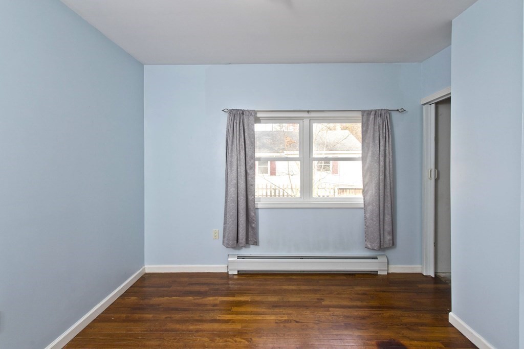 606 County Road Holyoke, MA 01040 - Photo 17 of 20 a view of an empty room with wooden floor and a window