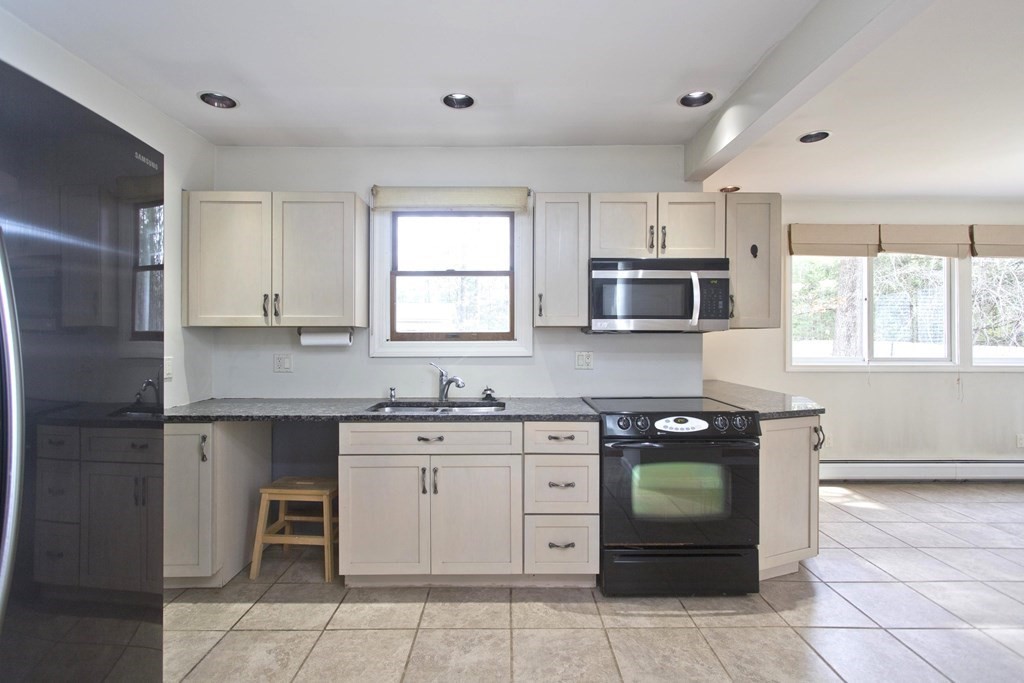 606 County Road Holyoke, MA 01040 - Photo 2 of 20 a kitchen with stainless steel appliances granite countertop a stove a sink and a refrigerator