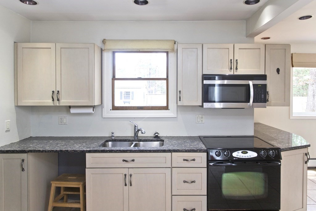 606 County Road Holyoke, MA 01040 - Photo 3 of 20 a kitchen with stainless steel appliances granite countertop a stove a sink and a microwave