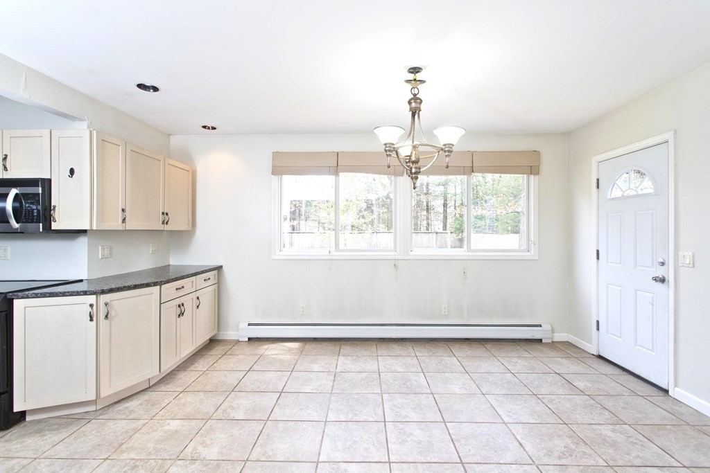 606 County Road Holyoke, MA 01040 - Photo 4 of 20 a kitchen with granite countertop white cabinets and window