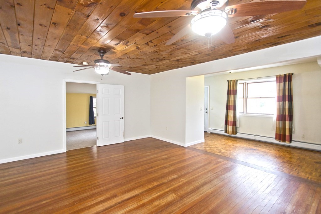 606 County Road Holyoke, MA 01040 - Photo 9 of 20 an empty room with wooden floor and windows