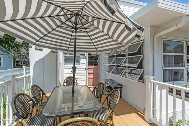 a backyard of a house with barbeque oven table and chairs