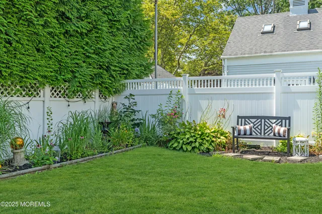 a view of a house with a yard and sitting area