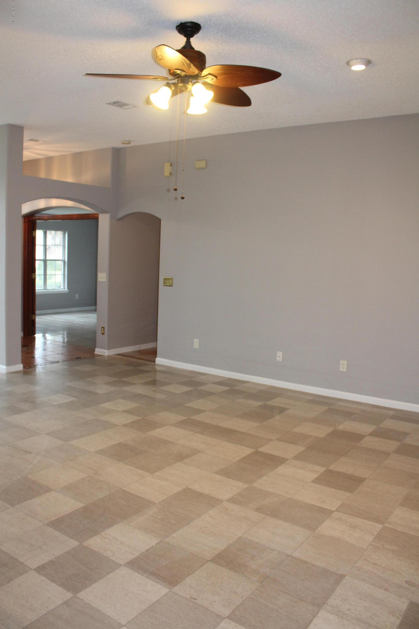2385 Mallory Hills Road Jacksonville, FL 32221 - Photo 10 of 45 a view of an empty room with a chandelier fan