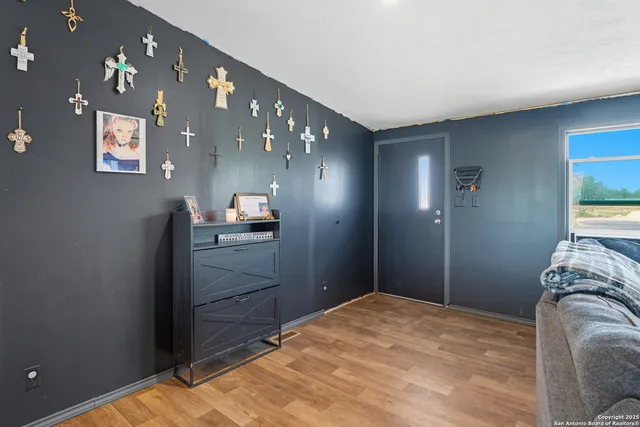 a bedroom with a bed and a lamp on dresser