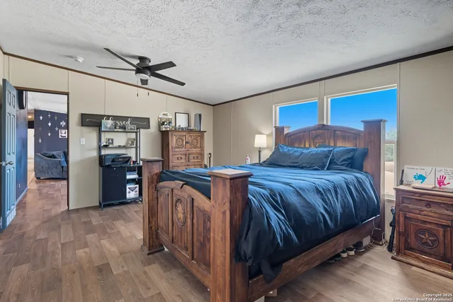 a bedroom with bed and wooden cabinets