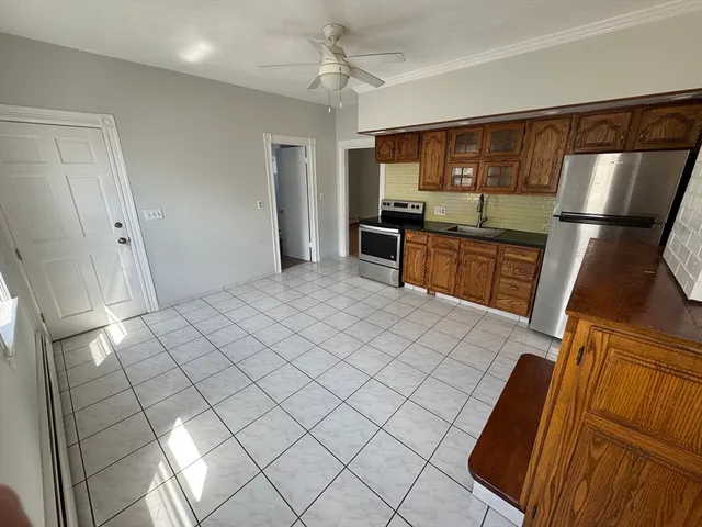 a kitchen with granite countertop a sink and a stove top oven