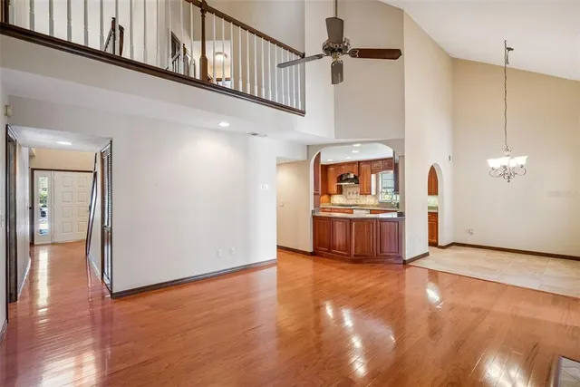 a view of a kitchen with fridge and wooden floor