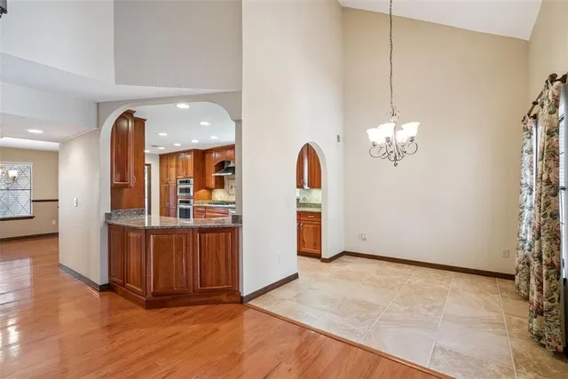 a view of a room with chandelier and wooden floors