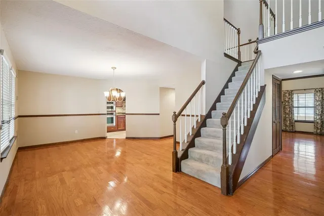 a view of entryway and hall with wooden floor