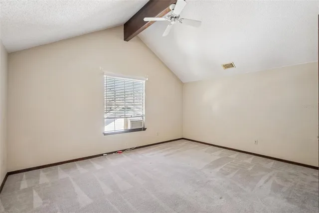 an empty room with a empty space and windows