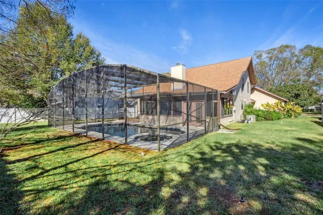 a view of a house with backyard and sitting area