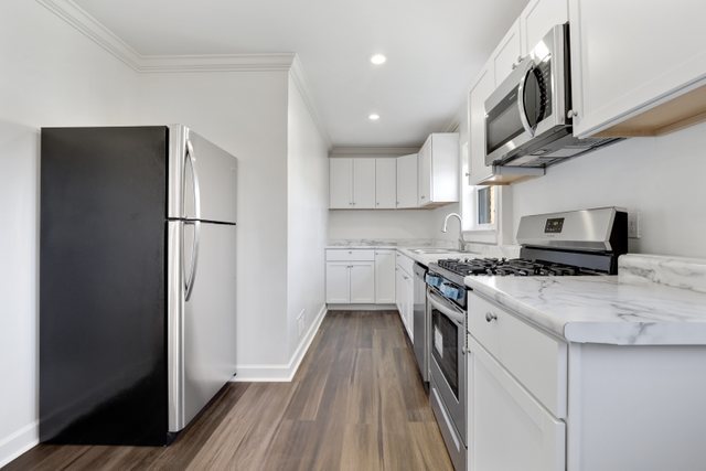 8012 Edgewater Road North Riverside, IL 60546 - Photo 5 of 22 a kitchen with stainless steel appliances granite countertop a refrigerator a stove a sink and a microwave