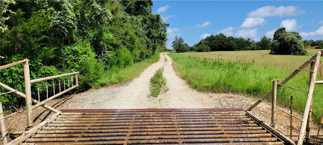 a view of a big yard with lots of green space and mountain view