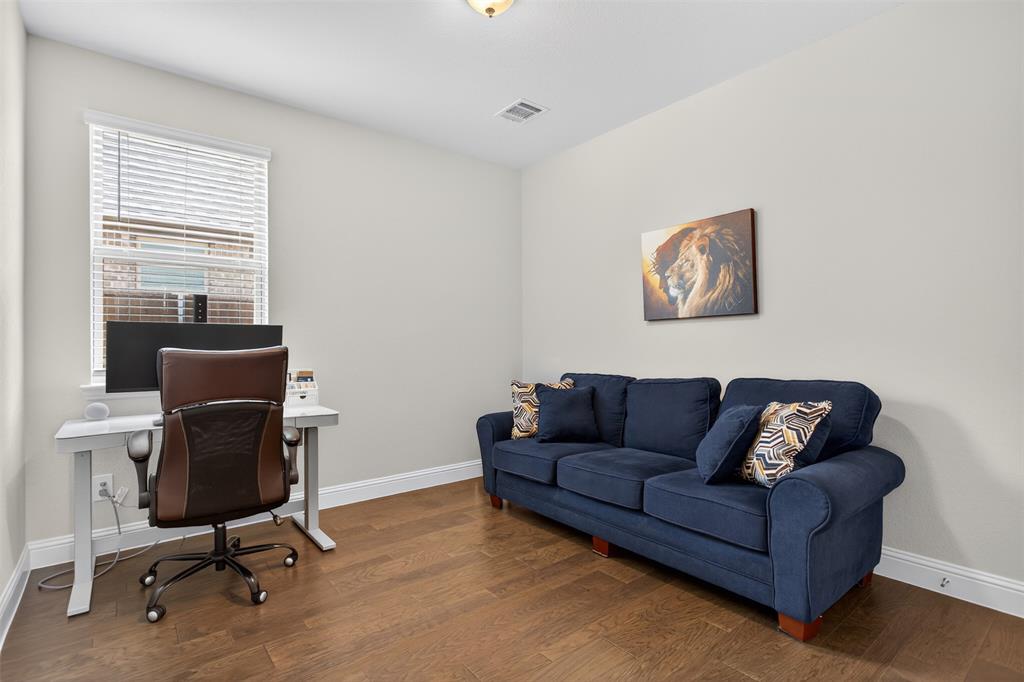 1002 Coppersmith Way Forney, TX 75126 - Photo 12 of 39 a living room with furniture and a window