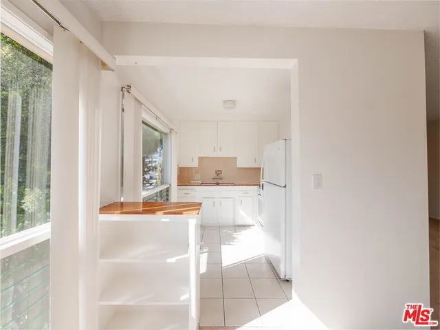 a view of a kitchen with kitchen island and windows