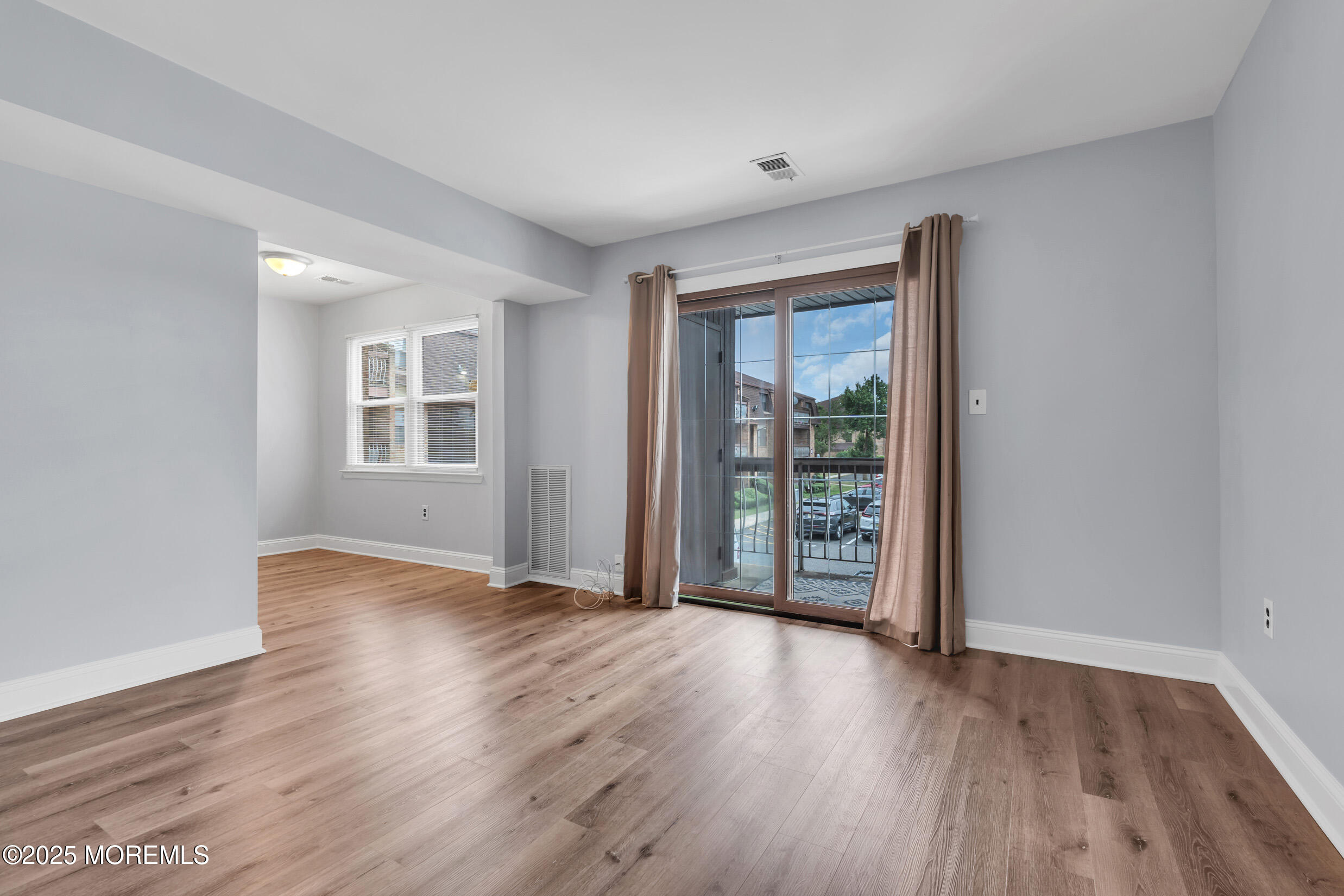 1617 Raspberry Court Edison, NJ 08817 - Photo 11 of 29 an empty room with wooden floor and windows