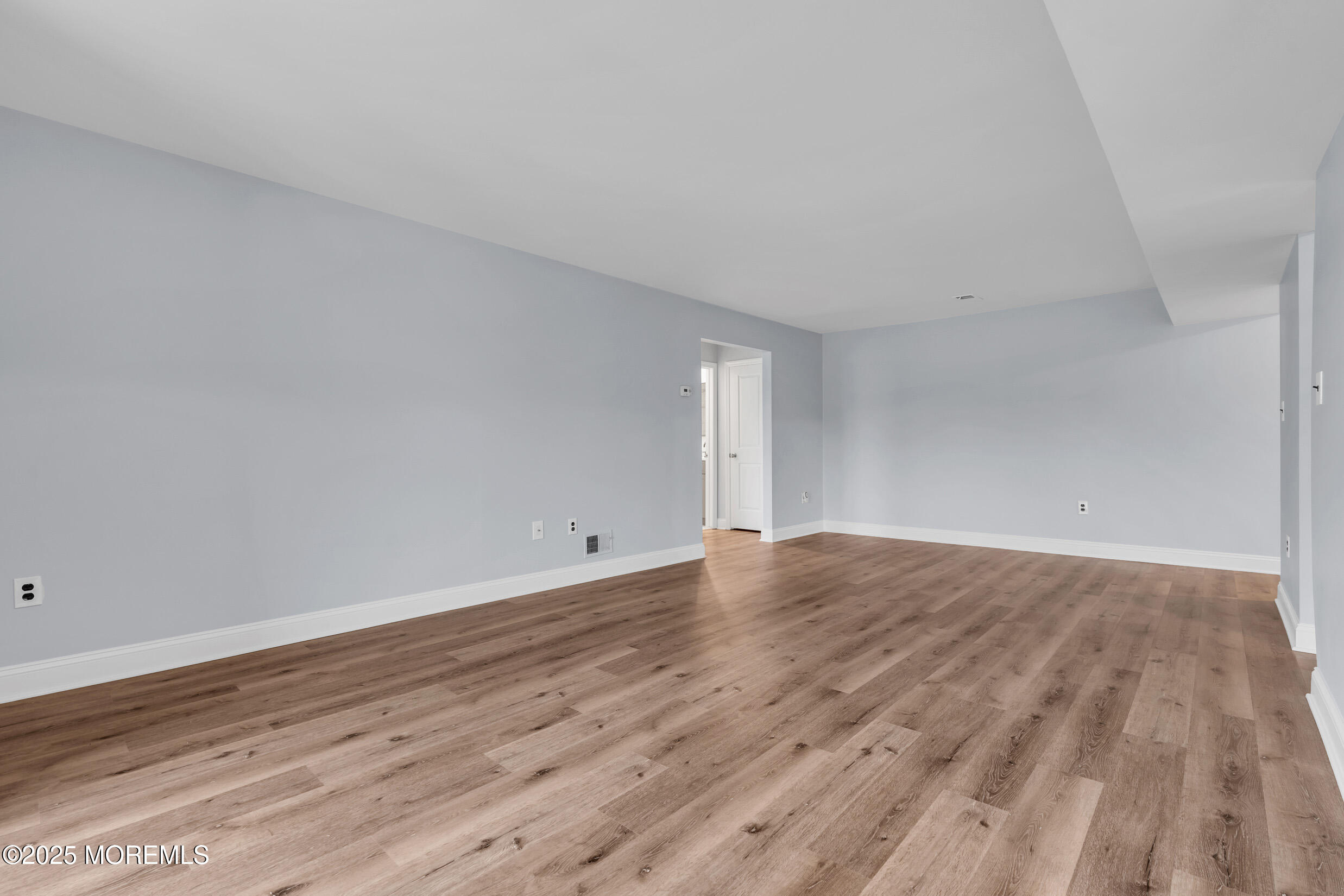 1617 Raspberry Court Edison, NJ 08817 - Photo 12 of 29 a view of an empty room with wooden floor